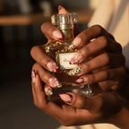 Dark skin hands holding perfume wearing leopard blossom 3D floral custom press-on nails inclusive beauty — LuxepressCo