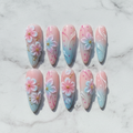 Flat lay top-down full set 10 cherry blossom press-on nails pink blue ombre marble background — LuxepressCo