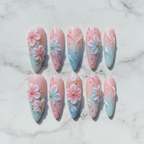 Flat lay top-down full set 10 cherry blossom press-on nails pink blue ombre marble background — LuxepressCo