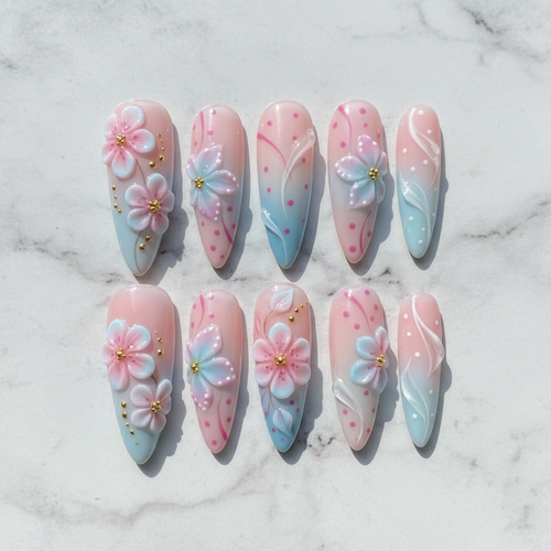 Flat lay top-down full set 10 cherry blossom press-on nails pink blue ombre marble background — LuxepressCo