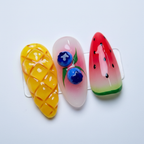 Macro close-up vivid yellow mango diamond grid 3D blue blueberry cluster red-green watermelon slice nail art — LuxepressCo