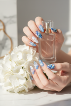 Fair skin lifestyle blue aurora floral gold butterfly iridescent custom press-on nails holding hydrangea luxury — LuxepressCo