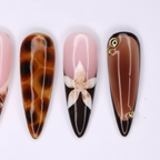 Macro close-up tortoiseshell 3D floral gold charm salon-quality nails — LuxepressCo