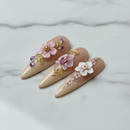 Close-up 3D white pink floral pearl center gold swirl reusable salon-quality nails marble background — LuxepressCo