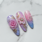 Close-up macro 3D floral press-on nails pink blue ombre water droplet texture gold chain pearl salon-quality nails — LuxepressCo