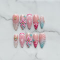 Flat lay top-down full set 10 mermaid shell 3D tropical flower jelly bubble salon-quality nails white marble — LuxepressCo