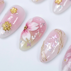 Macro close-up pink 3D cherry blossom sakura gold charm iridescent foil custom press-on nails — LuxepressCo
