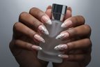 Dark skin hands holding silver frosted perfume wearing silver chrome botanical custom press-on nails nude bridal — LuxepressCo