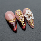 Close-up macro burgundy chrome gold filigree 3D pearl flower custom press-on nails dramatic lighting — LuxepressCo