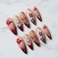 Crimson orchid 3D gold filigree press-on nails hero shot white marble studio custom press-on nails — LuxepressCo