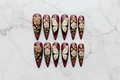 Flat lay top-down full set 10 burgundy gold rose butterfly custom press-on nails overhead studio shot — LuxepressCo