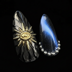 Macro close-up 3D gold sun eye charm and blue cat eye chrome salon-quality press-on nails dark marble — LuxepressCo