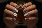 Dark skin hands holding amber perfume wearing brown rhinestone boho custom press-on nails inclusive beauty — LuxepressCo