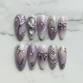 Flat lay top-down full set 10 lavender chrome 3D bow heart almond press-on nails marble background custom press-on nails — LuxepressCo