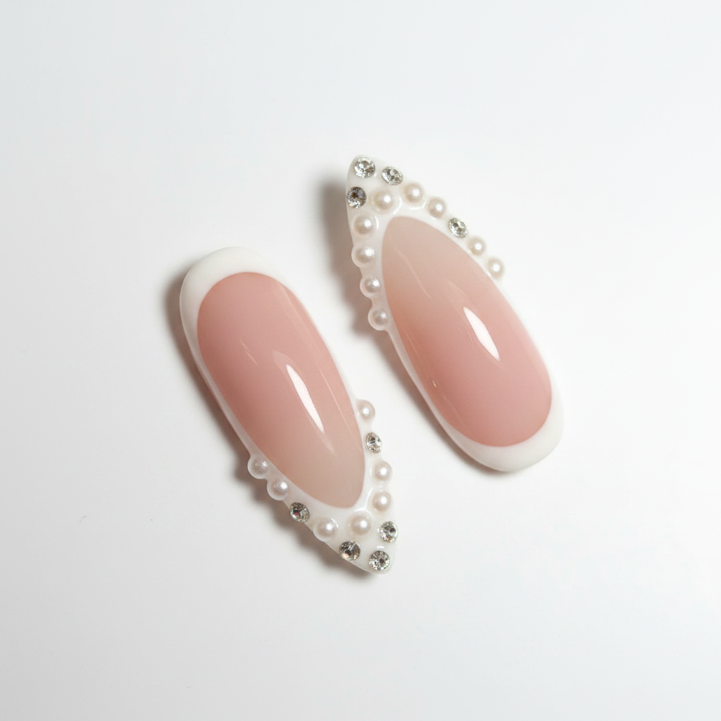Macro close-up nude blush white French tip micro pearl crystal rhinestone scalloped border salon-quality almond press-on nails — LuxepressCo