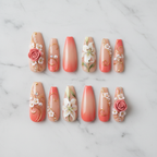 Flat lay top-down full set 10 3D floral press-on nails peach nude stiletto studio — LuxepressCo