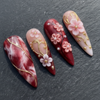 Macro close-up 3D cherry blossom rhinestone burgundy marble custom press-on nails dramatic lighting — LuxepressCo