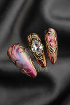 Macro close-up 3D gold filigree crystal chrome press-on nails dramatic lighting — LuxepressCo