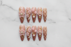 Flat lay top-down full set 10 luxury 3D floral pearl gold press-on nails marble background reusable nails — LuxepressCo