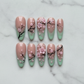 Flat lay top-down full set 10 sakura press-on nails white marble overhead studio shot — LuxepressCo