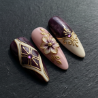 Close-up macro purple marble gold baroque geometric rhinestone custom press-on nails dramatic lighting — LuxepressCo