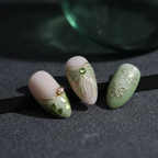 Sage green ombre French tip gold wire butterfly bow charm macro close-up dramatic dark background custom press-on nails — LuxepressCo