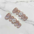Aurora shimmer custom press-on nails nude beige 3D flower gold foil short oval marble studio — LuxepressCo