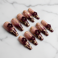 Burgundy gold 3D floral press-on nails full set on marble background studio light custom press-on nails — LuxepressCo