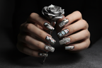 Fair-skin hands wearing silver chrome aurora custom press-on nails holding silver metallic rose — LuxepressCo