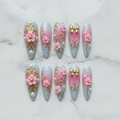 Flat lay top-down full set 10 luxury stiletto press-on nails pink gold floral pearl — LuxepressCo