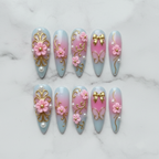 Flat lay top-down full set 10 luxury stiletto press-on nails pink gold floral pearl — LuxepressCo