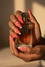 Dark skin hands wearing red orange citrus custom press-on nails holding perfume bottle — LuxepressCo