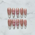 Flat lay top-down 10 dusty rose pink magnolia gold filigree pearl custom press-on nails white marble — LuxepressCo