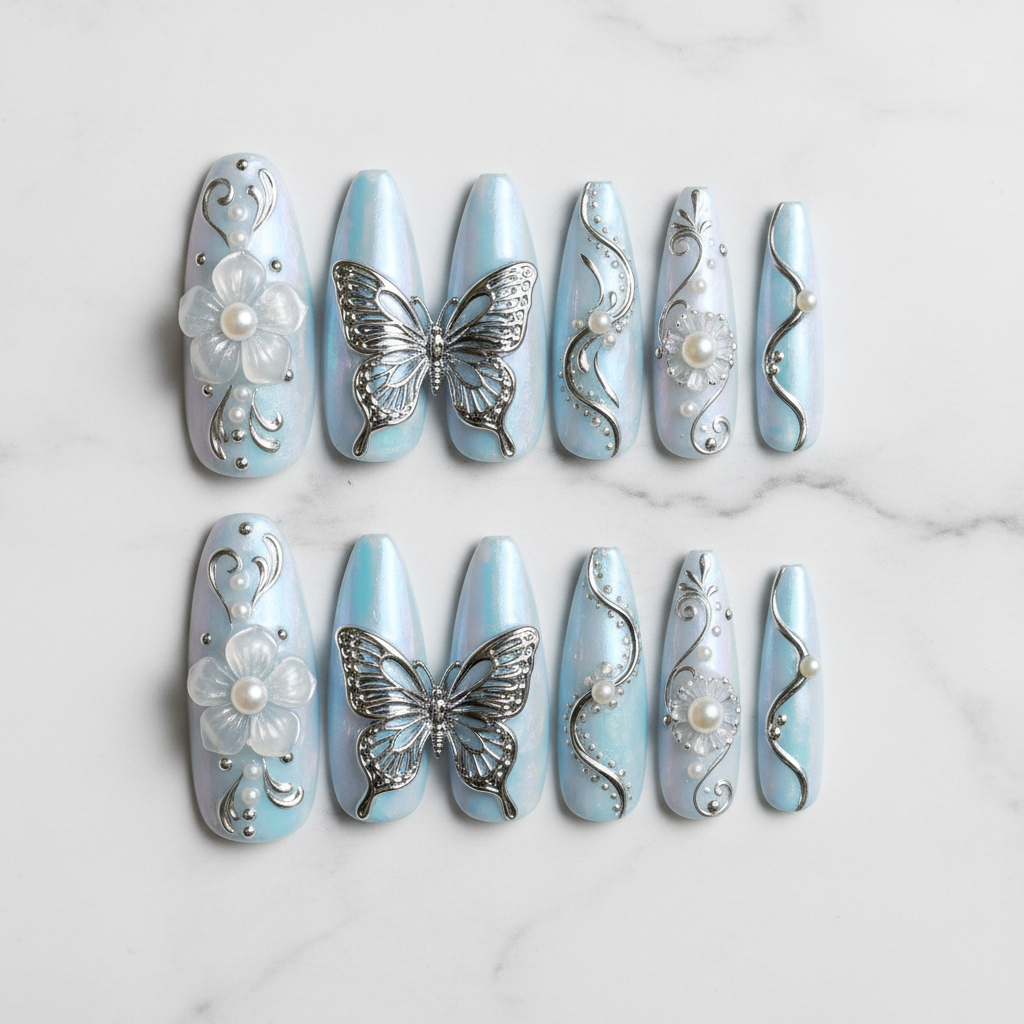 Flat lay top-down full set 10 silver butterfly 3D chrome custom press-on nails opal blue stiletto — LuxepressCo