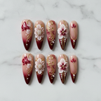 Flat lay top-down full set 10 burgundy 3D floral pearl gold filigree custom press-on nails white marble — LuxepressCo