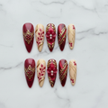 Flat lay top-down full set 10 burgundy cream gold baroque custom press-on nails studio — LuxepressCo