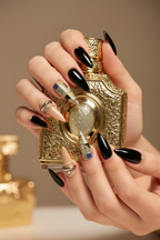 Light skin hands with nude gold chrome teal gemstone mixed reusable nails holding perfume — LuxepressCo