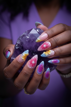 Dark skin hands wearing aurora daisy 3D floral custom press-on nails holding purple amethyst crystal — LuxepressCo