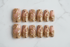 Flat lay top-down full set 10 gold rhinestone swirl press-on nails white marble — LuxepressCo