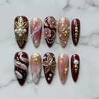 Flat lay top-down view 10 burgundy gold pearl 3D floral custom press-on nails — LuxepressCo
