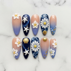 Flat lay top-down full set 10 ocean blossom almond press-on nails blue floral gold foil pearl — LuxepressCo