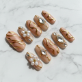 Champagne pearl 3D white flower gold chrome swirl crystal rhinestone custom press-on nails nude bridal full set flat lay — LuxepressCo