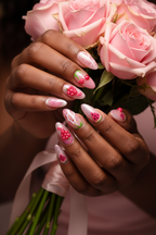 Dark skin hands wearing pink jelly fruit custom press-on nails holding pink rose bouquet — LuxepressCo