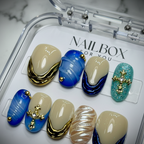 Macro close-up cobalt blue wave French tip 3D ribbed chrome gold cross reusable salon-quality press-on nails — LuxepressCo