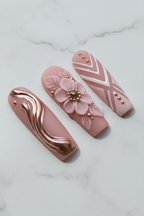 Close-up rose gold metallic wave swirl and geometric chevron blush pink salon-quality press-on nails — LuxepressCo