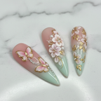 Close-up gold filigree rhinestone mint green blush pink custom press-on nails glossy texture — LuxepressCo