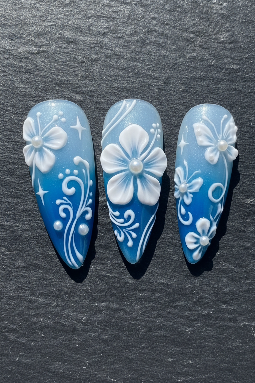 Macro close-up 3D white floral pearl embellishment blue ombre custom press-on nails dramatic lighting — LuxepressCo