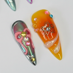 Macro close-up teal chrome pink 3D bow and orange jelly sculpted fabric salon-quality press-on nails — LuxepressCo