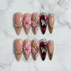 Burgundy butterfly gold swirl 10 custom press-on nails flat lay top-down studio marble — LuxepressCo