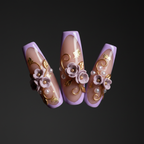 Macro close-up 3D purple clay flower press-on nails with gold metallic vine dramatic lighting — LuxepressCo